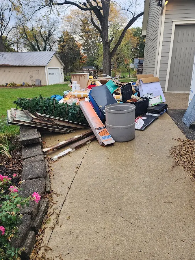 Dumpster being loaded with debris for Residential Dumpster Rental in Melissa